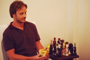 Dionisis admires an Orisha doll