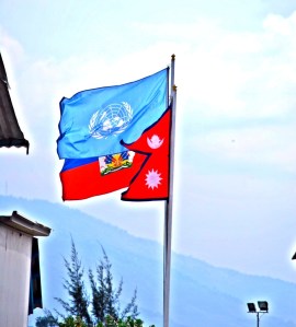 The Haitian, UN and Nepalese flag fly in unison